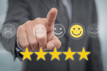 Person touching happy face icon and five yellow stars for customer satisfaction customer feedback rating