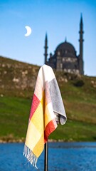 Colorful cloth draped against a mosque backdrop