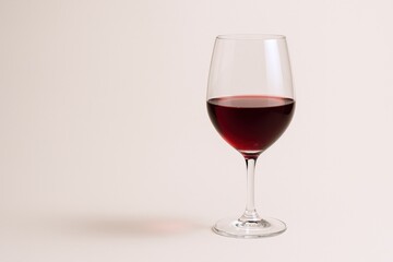 Elegant Glass of Red Wine Against a Neutral Background, Ideal for Advertising and Product Mockups