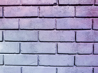 Close-up of a pastel-painted brick wall with a soft purple gradient and textured surface, ideal for backgrounds, design work, or creative projects.
