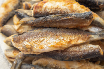 Stack of fish fillets with a crispy texture. Concept of abundance and satisfaction, as the fish are cooked to perfection and ready to be enjoyed
