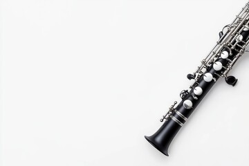 A beautifully crafted oboe rests on a pristine white surface, showcasing its elegant design and shiny keys