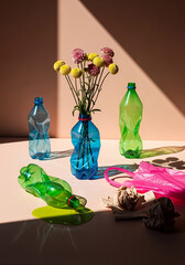 Flowers in Recycled Plastic Bottles with Spilled Liquid and Plastic Bags