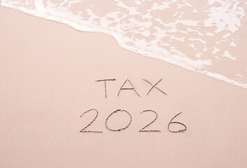 TAX 2026 handwritten with ocean waves on a sandy beach.