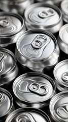 Close-up view of multiple aluminum beverage cans stacked together in a neatly organized arrangement