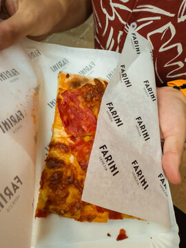 07.21.2025, Venice, Italy. Traditional Italian pizza slice with salami and cheese served at Farini Venezia pizzeria