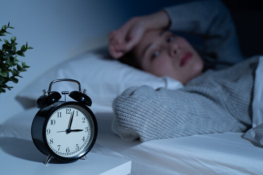 Anxiety disorder on insomnia woman concept, sleepless Woman open eye awakening on the bed at night time can't sleep from symptom of depression diseased.