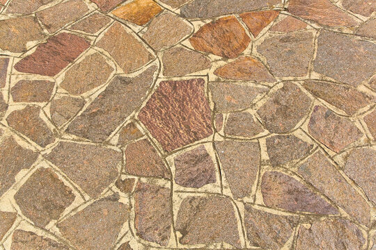 STONE PORPHYRY PAVING made with porphyry stone blocks of irregular shape, called opus incertum, in a pedestrian zone