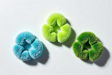 recycling symbols, three fluffy in different shades of green on a white background, symbolizing eco-friendly practices and sustainability.