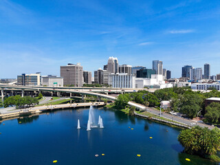 View looking over the Lake Lucerne fountain and the downtown Orlando skyline in Orange County, Orlando, Florida, USA. 