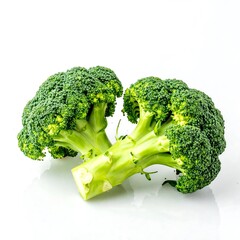 Two vibrant green broccoli florets rest on a pristine white surface, showcasing their fresh, healthy appearance.