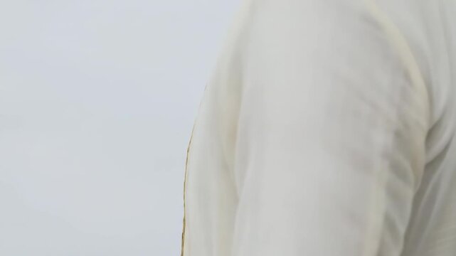 traditional barong tagalog with intricate gold embroidery on light fabric backdrop. cultural attire, showcasing elegant craftsmanship. ceremony, cultural event, fashion