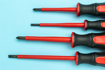 Insulated Screwdrivers on Blue Background: Essential Tools for Electrical Safety and Precision Work