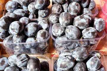 Fruits glisten under sunlight at vibrant market stall in autumn