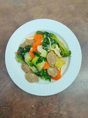 Capcay is a typical Chinese-Indonesian dish consisting of various types of vegetables cooked by boiling or stir-frying. Separated on a white background.