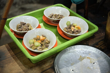 Empal Gentong is a traditional Indonesian beef soup originating from Cirebon, West Java. This savory dish is made from beef and offal cooked in a rich coconut milk broth.