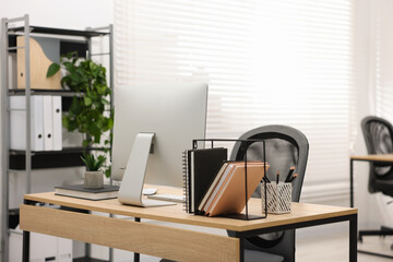 Stylish workplace with modern computer and stationery on wooden table in office