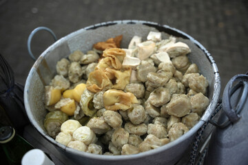 Siomay in the pan and ready to be sold. Siomay are fish cake dumplings with potatoes, eggs and rolled cabbage served with peanut sauce and chili. Siomay is a traditional Indonesian culinary food.