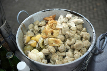 Siomay in the pan and ready to be sold. Siomay are fish cake dumplings with potatoes, eggs and rolled cabbage served with peanut sauce and chili. Siomay is a traditional Indonesian culinary food.