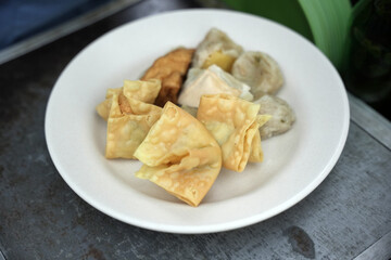 Siomay in the pan and ready to be sold. Siomay are fish cake dumplings with potatoes, eggs and rolled cabbage served with peanut sauce and chili. Siomay is a traditional Indonesian culinary food.
