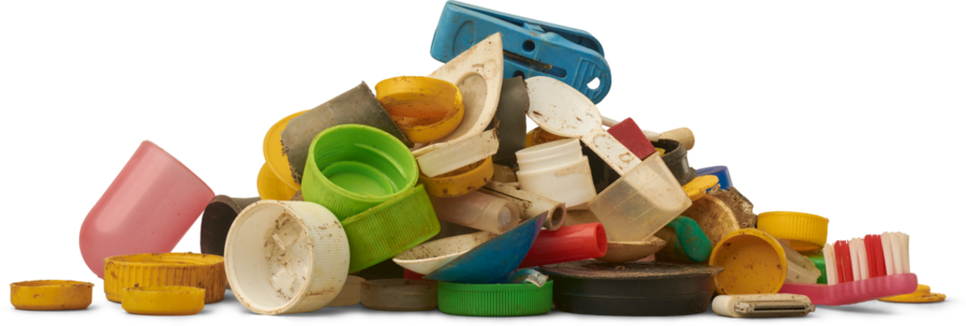 pile of dirty weathered plastic waste including bottle caps, toy parts, toothbrush, and fragments isolated white background, pollution and environmental harm concept