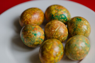 Colorful marbled Easter eggs on plate, festive Orthodox holiday food