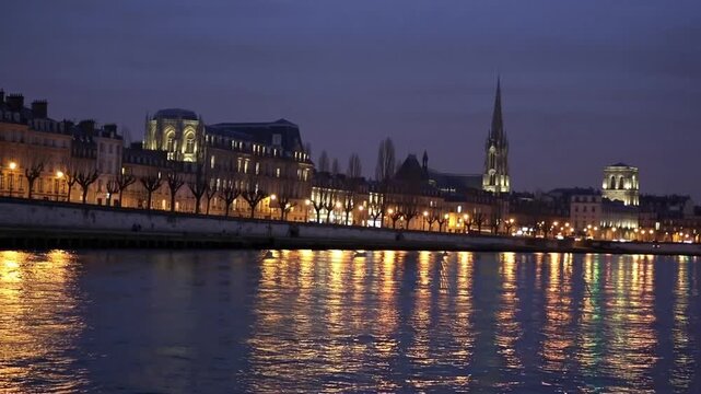 The riverbank of major river alongside historic cathedral during the evening in European city during the colder season