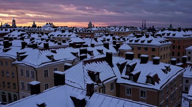 Sunset over Roofs Winter sunset over snow covered old buildings roofs, Stockholm, Sweden.