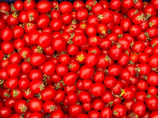 Cherry tomatoes in vibrant red color filling entire surface. Agriculture, farming, and seasonal vegetable harvest with nutrition and natural lifestyle.