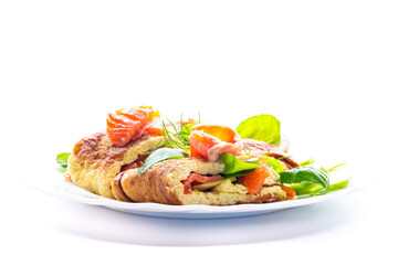 Omelet with red fish and fresh herbs on a white plate