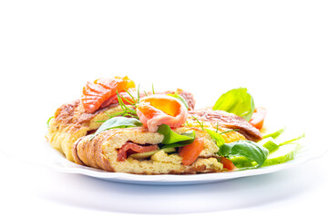 Egg omelet with salmon and spinach leaves for breakfast