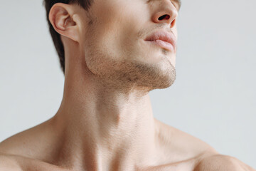closeup shot highlighting chin and collarbones in athletic pose against solid ultrabright background
