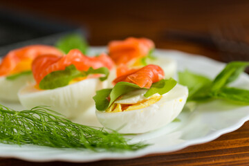 Cold festive appetizer of eggs with fish slices