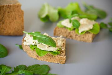 Homemade rye bread with herring paste and arugula