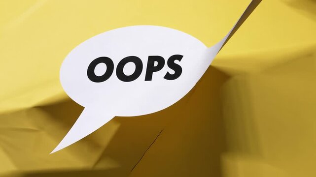 paper speech bubble with the word OOPS on yellow background top view flat lay with copy space