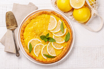 Delicious lemon tart with golden crust and smooth, glossy lemon filling
