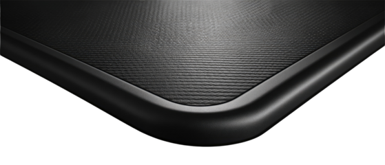 Close-up of a dark gray or black surface with a textured finish and a rounded edge