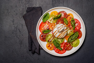 Fresh burrata served on slices of colorful tomatoes