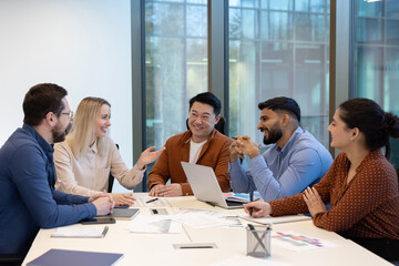 Diverse business team discussing strategy in modern office