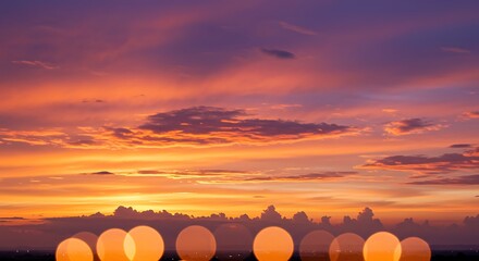 Vibrant Sunset Sky with Bokeh Lights Over Cityscape