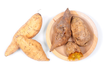 Sweet Cilembu sweet potatoes, raw and roasted on wooden plate, showing golden soft texture, healthy traditional Indonesian food.