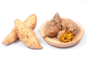 Cilembu sweet potatoes on a white background, showing raw yellow tubers beside roasted ones with caramelized flesh, highlighting natural freshness, nutrition, and organic taste.