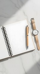 Open Notebook, Pen, and Watch on a Marble Desk