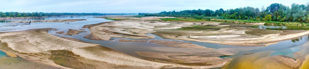 Aerial panoramic view of dried riverbed during record summer drought, historic low water level of the Vistula river in Poland.