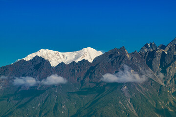 Beautiful first light from sunrise on Mount Kabru, part of ridge that extends south from third highest mountain in the world Kangchenjunga, Himalayan mountain range, Sikkim, India. Nepal India border.