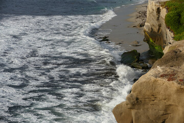 Pacific shore with white wave and blue ocean