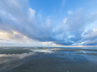 Fototapeta premium Low Tide Reflections under a Dramatic Cloudy Sky