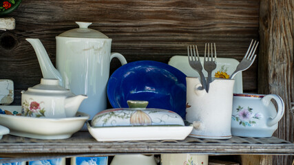Vintage Porcelain Dishes and Cutlery on Rustic Wooden Shelf – Countryside Kitchen