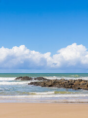 Wide Sandy Beach with Tropical Cliffs and Blue Sky