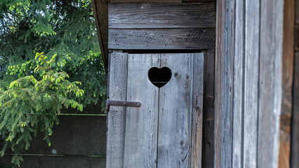 Rustic Wooden Outhouse Door with Heart Cutout – Countryside Architecture